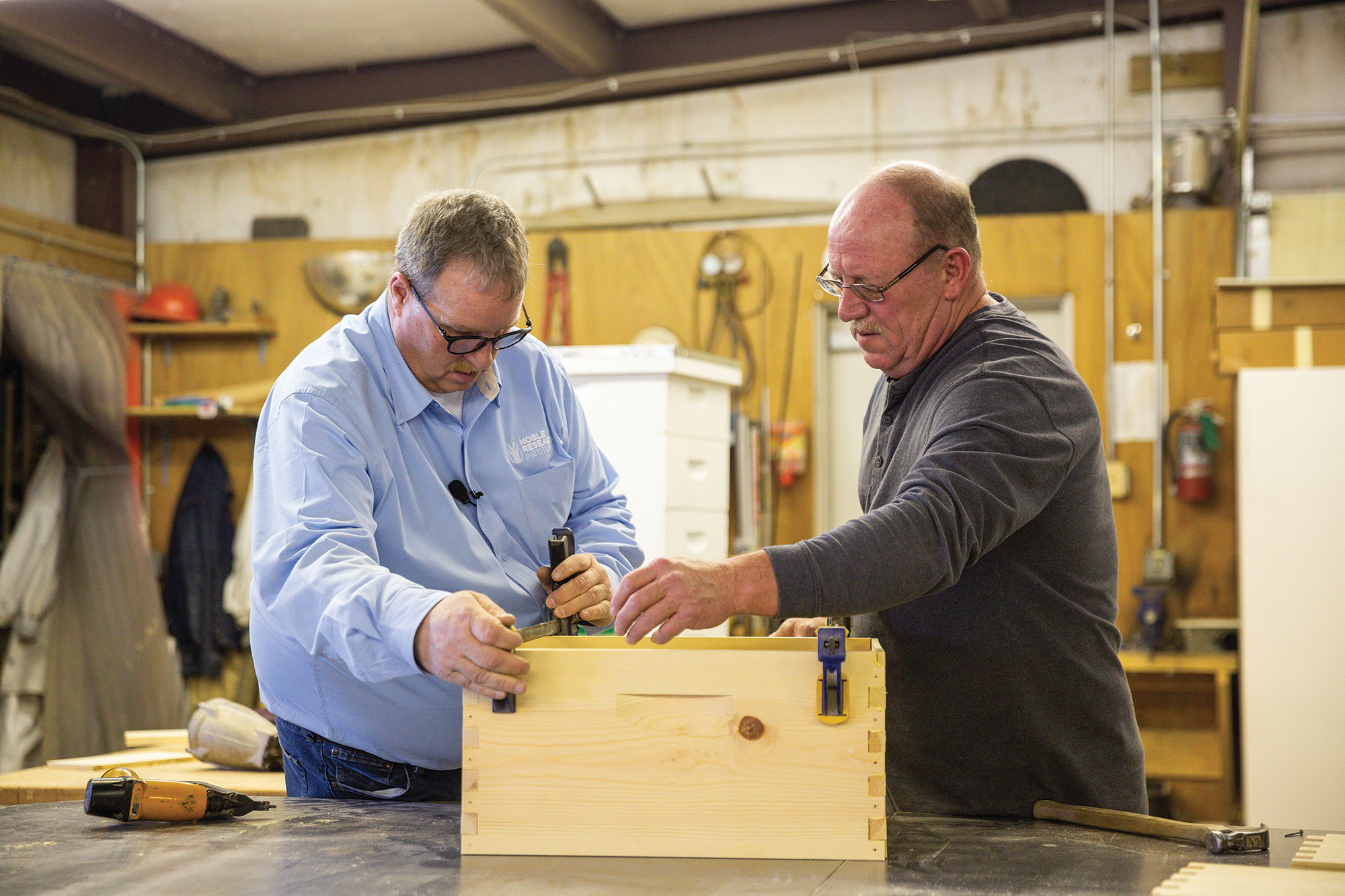 Charlie Canny and Pat Tickel assemble a beehive.